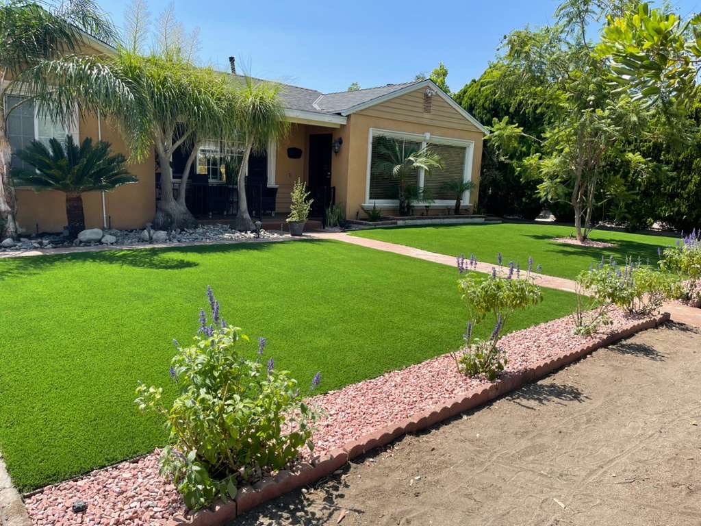 Front yard artificial turf with brick edging and landscaping