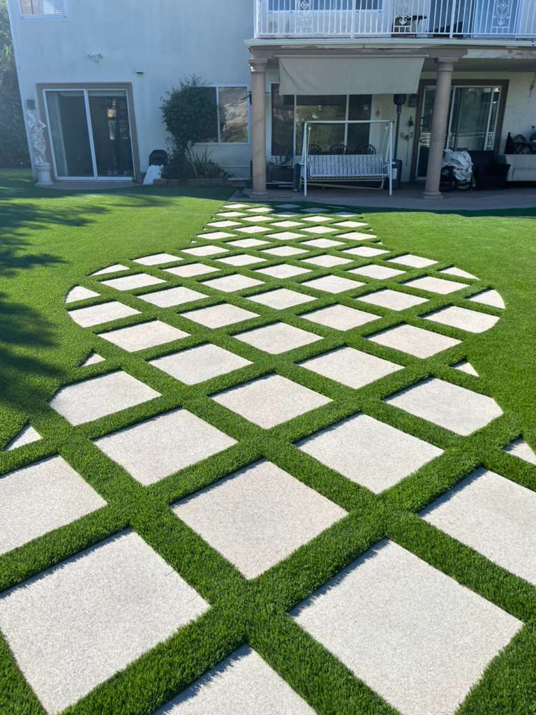 Diamond pattern pavers with artificial turf backyard