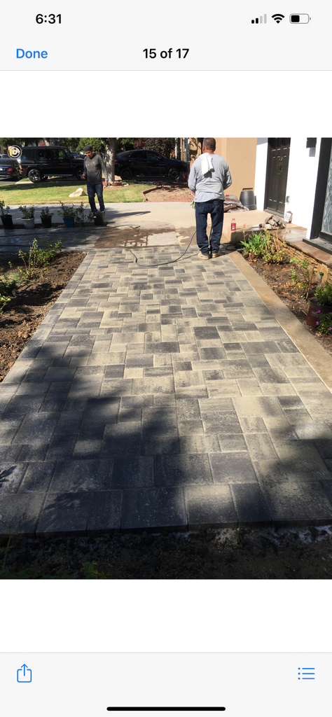 Gray paver walkway being professionally sealed