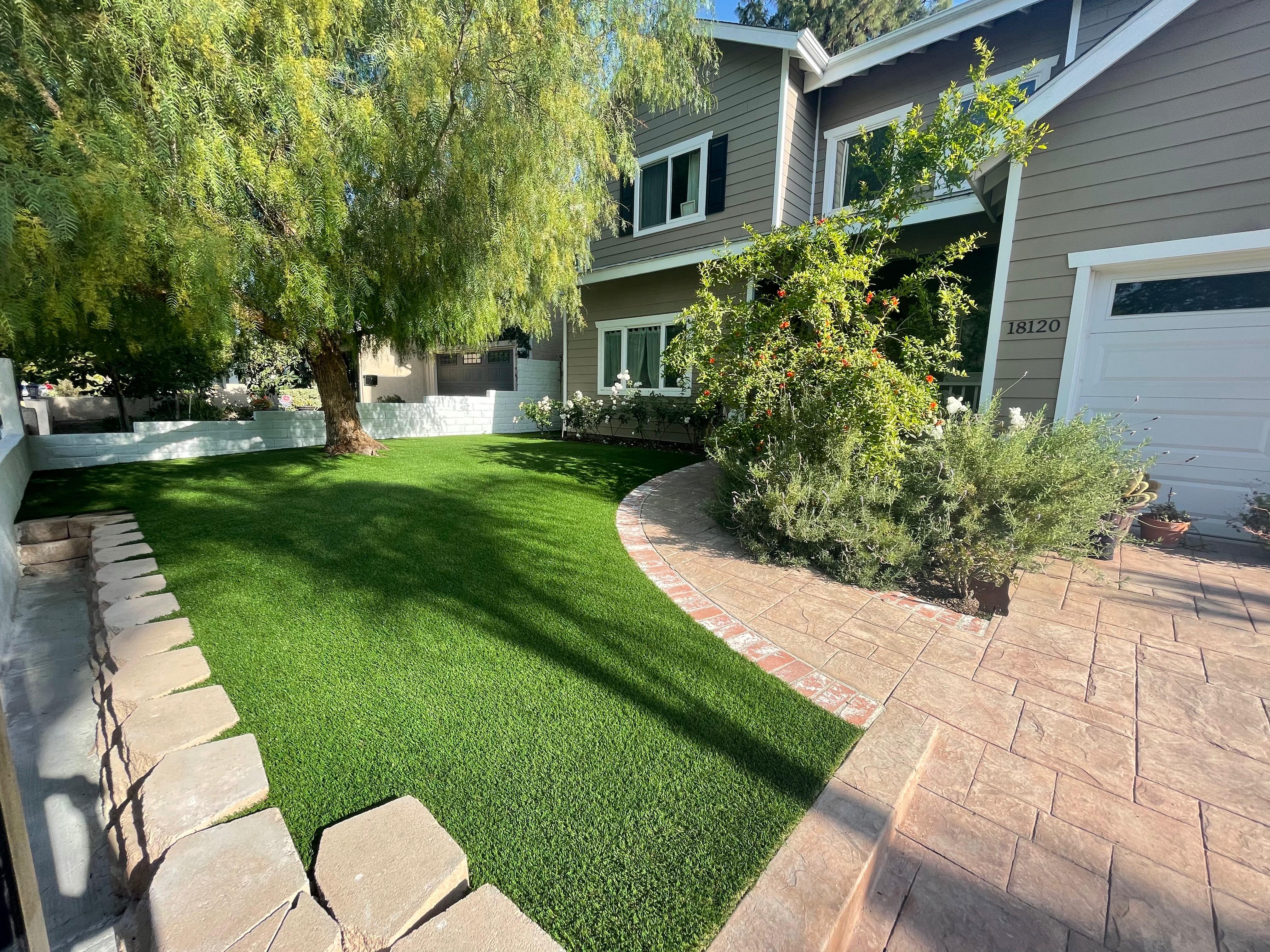 Front yard with curved stamped concrete and brick border
