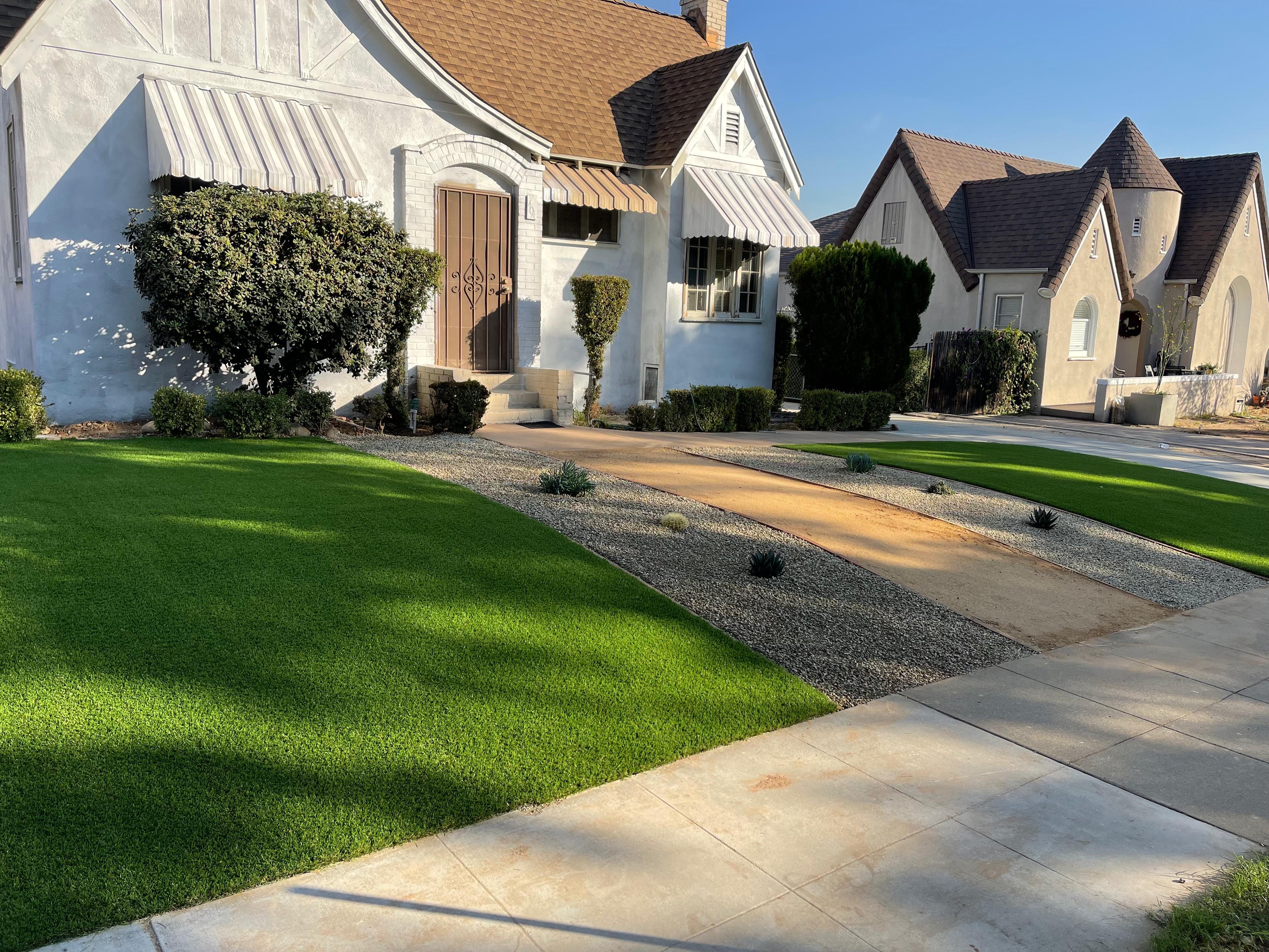 Front yard turf with gravel accents and storybook homes