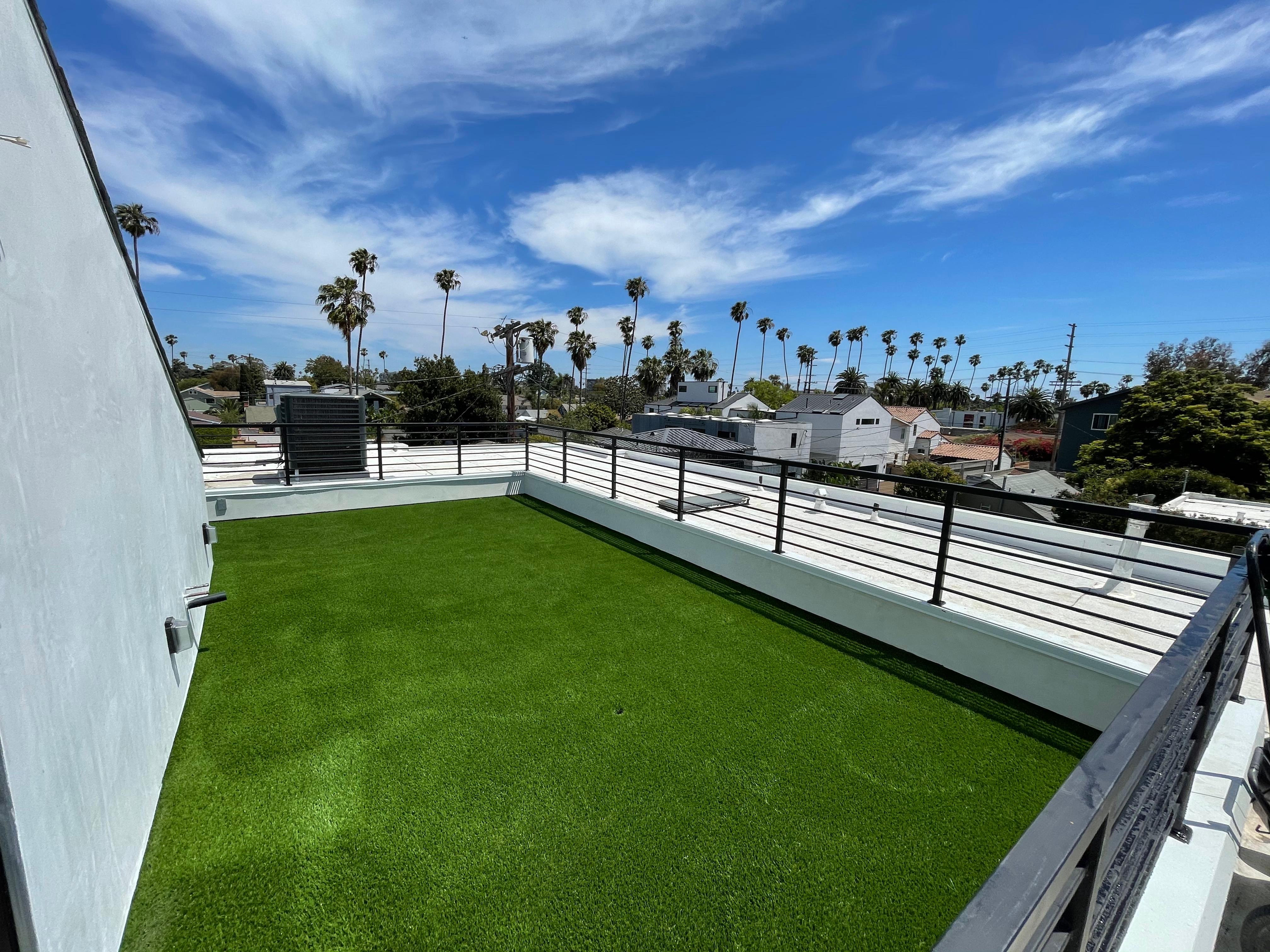 Rooftop deck with artificial turf and city views