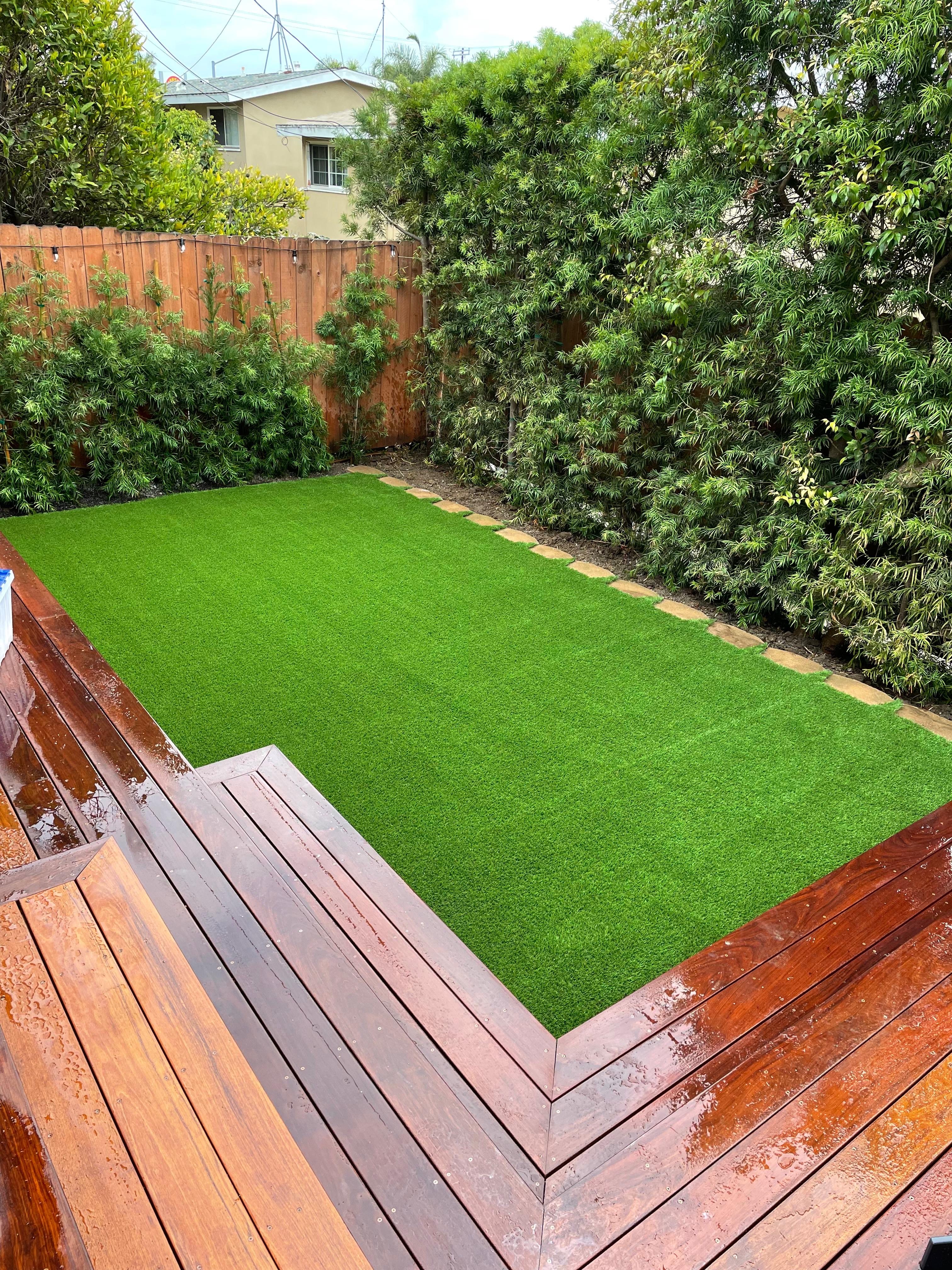 Wood deck with artificial turf backyard