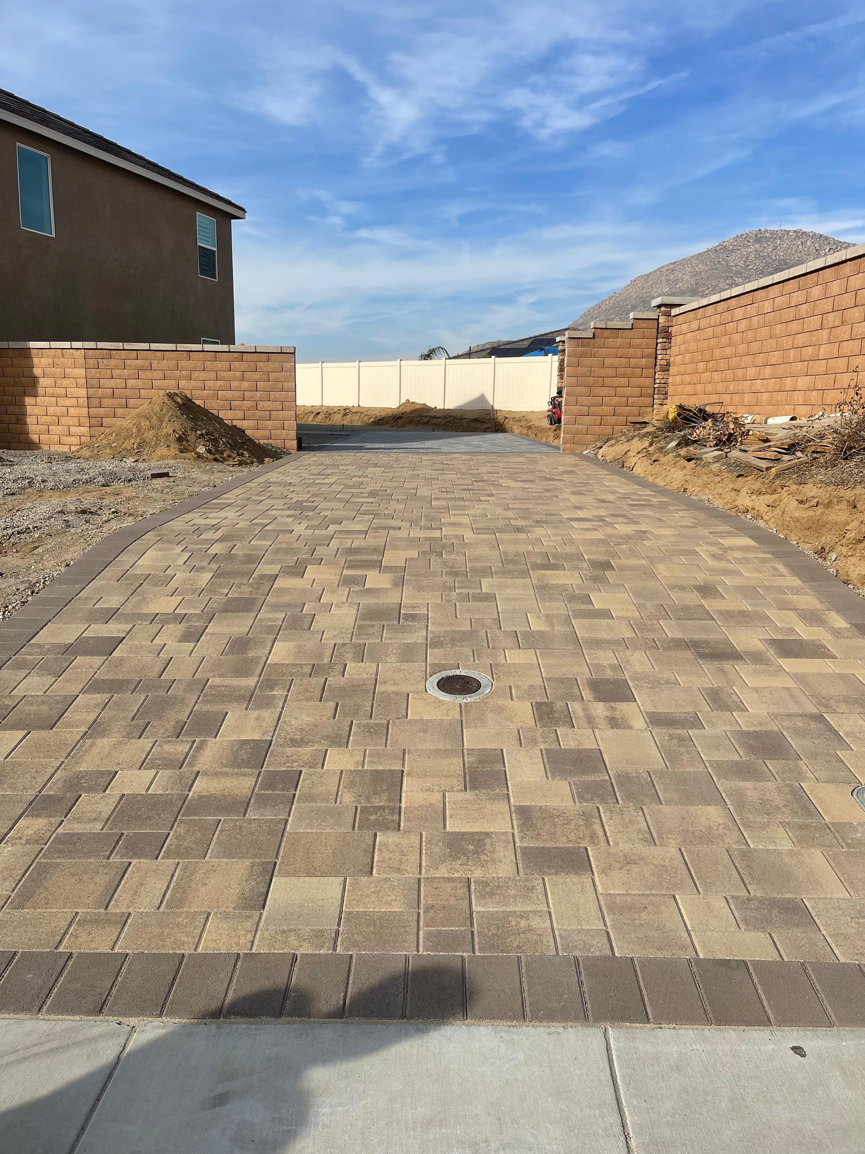 Long paver driveway with mountain backdrop