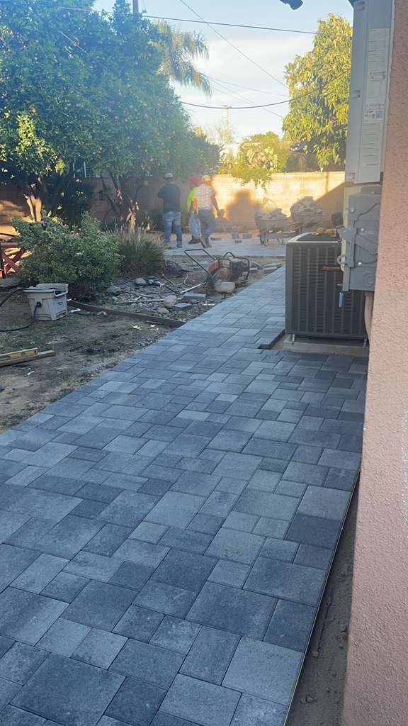 Gray paver side yard pathway installation in progress